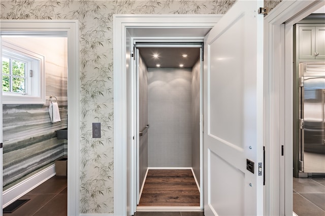 interior space featuring elevator and hardwood / wood-style floors