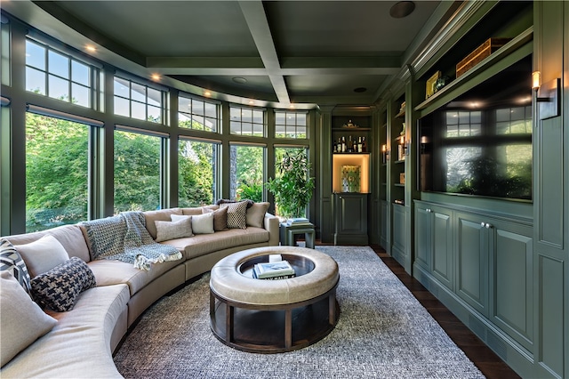 living room featuring built in features, coffered ceiling, dark hardwood / wood-style floors, and beam ceiling