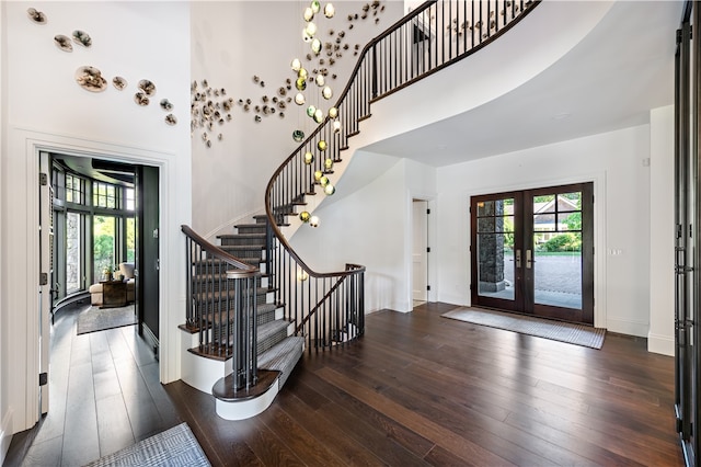 entrance foyer featuring dark wood-type flooring, a high ceiling, and french doors