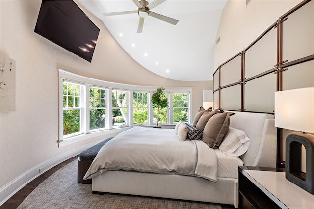 bedroom with ceiling fan, high vaulted ceiling, and dark hardwood / wood-style flooring