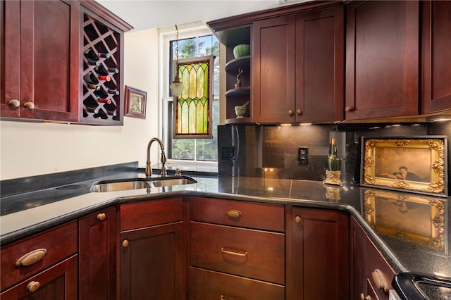 kitchen featuring a wealth of natural light, sink, and backsplash