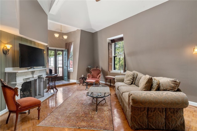 living room featuring high vaulted ceiling, light parquet floors, and a high end fireplace