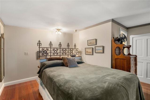 bedroom featuring dark hardwood / wood-style flooring and crown molding