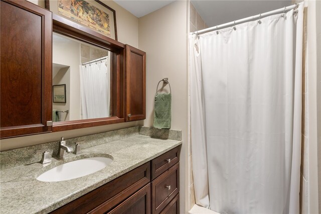 bathroom featuring vanity and curtained shower