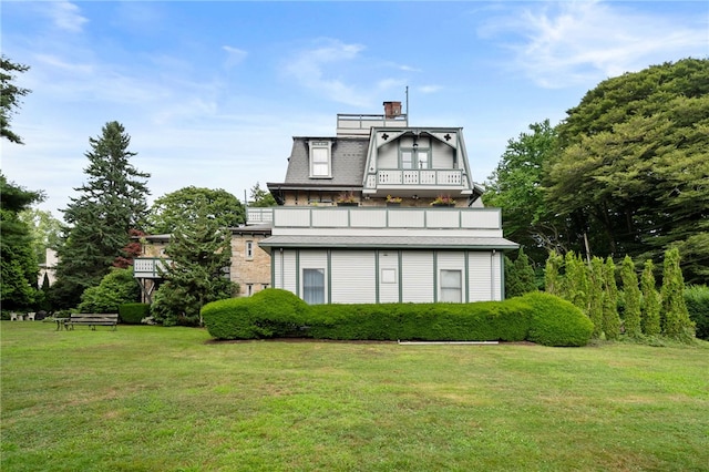 rear view of property featuring a yard