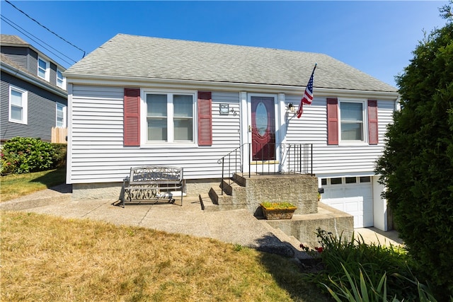 view of front facade with a front yard and a garage