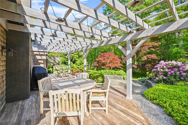 wooden deck featuring a pergola and grilling area