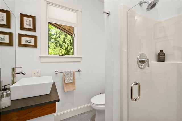 bathroom featuring tile patterned flooring, vanity, walk in shower, and toilet