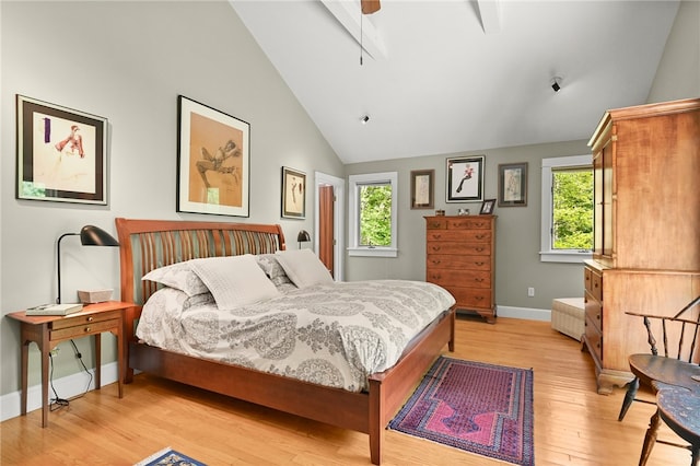 bedroom featuring high vaulted ceiling, light hardwood / wood-style flooring, multiple windows, and ceiling fan