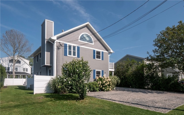 back of house featuring a yard and central air condition unit