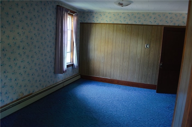 spare room with carpet flooring, a baseboard radiator, and a healthy amount of sunlight