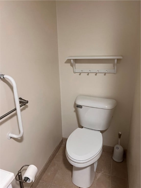 bathroom featuring tile patterned flooring and toilet