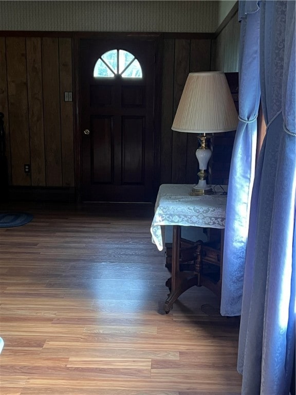 entrance foyer with hardwood / wood-style flooring and wood walls