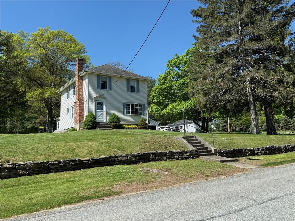 505 Central St, Burrillville, RI 02839 - view of front facade with entry steps, a chimney, and a front yard
