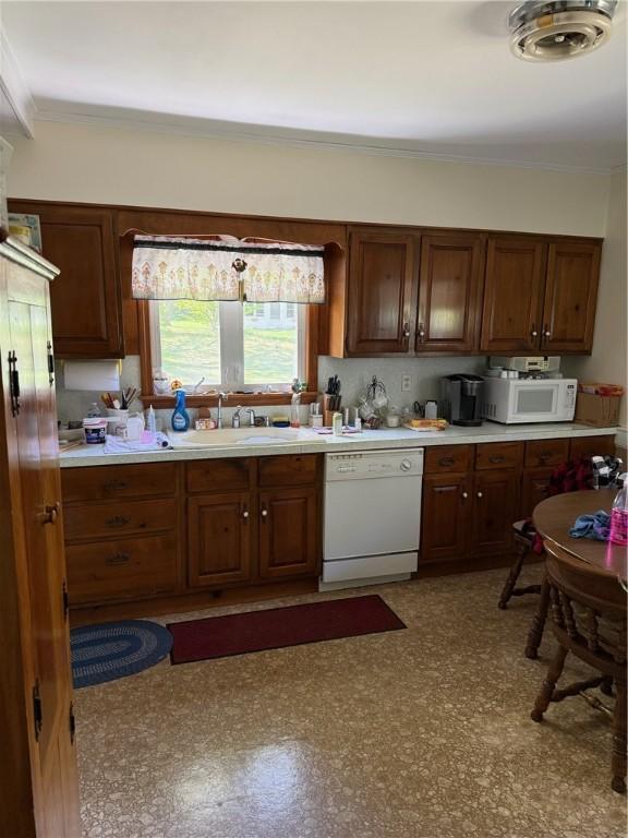 505 Central St, Burrillville, RI 02839 - kitchen with white appliances, a sink, light countertops, and ornamental molding