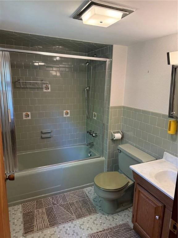 505 Central St, Burrillville, RI 02839 - full bathroom featuring vanity, washtub / shower combination, a wainscoted wall, tile walls, and toilet