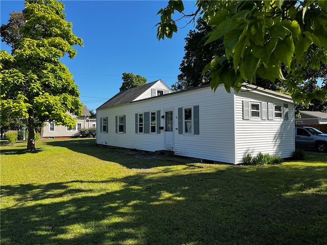 rear view of house with a lawn