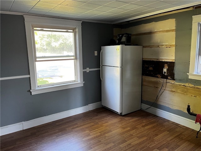 kitchen with ornamental molding, white refrigerator, and dark wood-type flooring