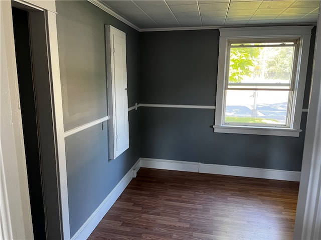 spare room with dark hardwood / wood-style floors and ornamental molding