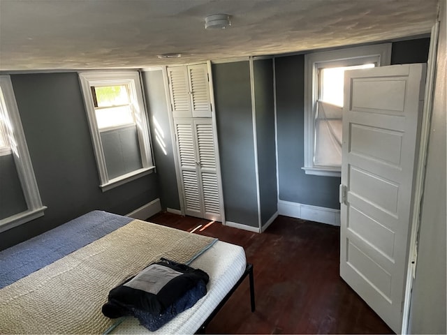 bedroom with dark hardwood / wood-style floors