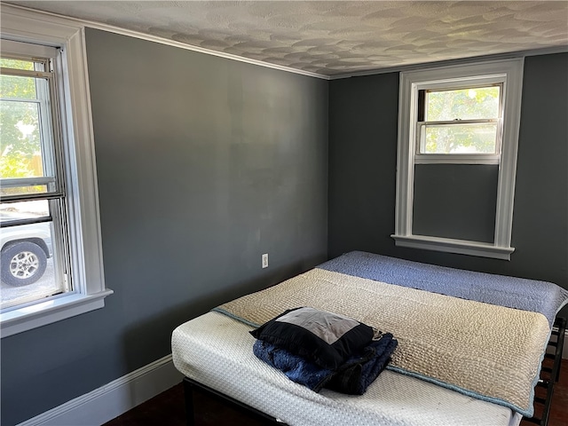 bedroom featuring a textured ceiling and multiple windows