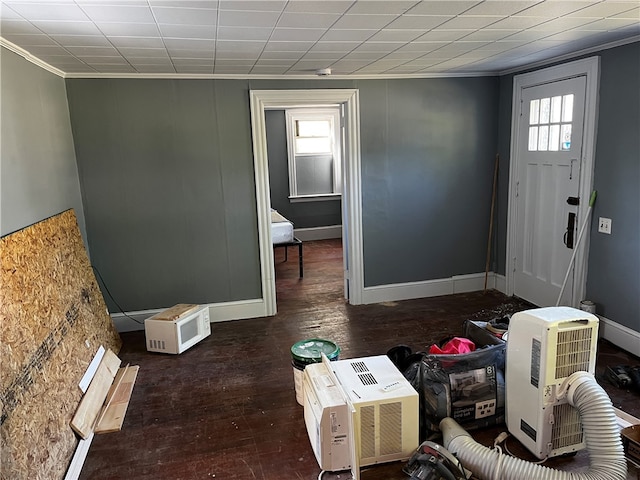 foyer with dark hardwood / wood-style flooring and crown molding