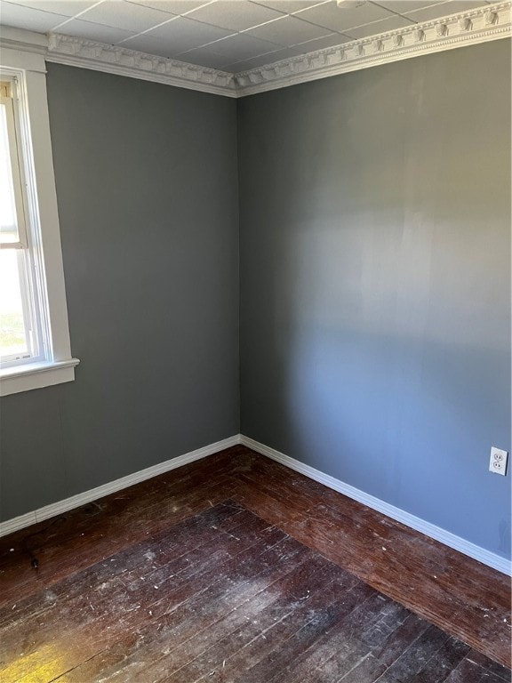 unfurnished room featuring wood-type flooring and a drop ceiling