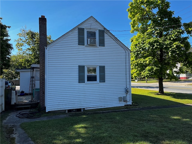 view of side of property with a yard