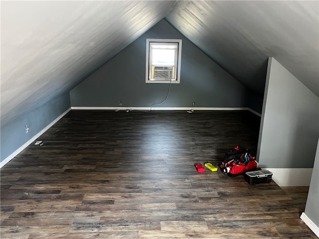 bonus room with vaulted ceiling, dark hardwood / wood-style flooring, and cooling unit