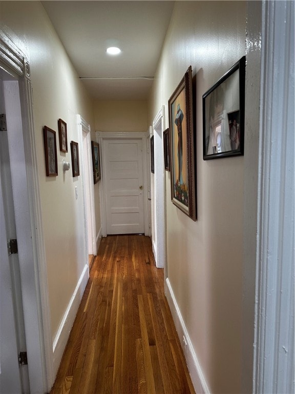 hallway with dark hardwood / wood-style flooring