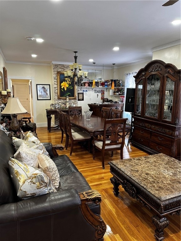 living room with ceiling fan, ornamental molding, and light hardwood / wood-style floors