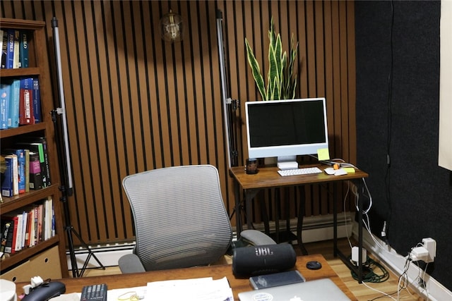 home office featuring hardwood / wood-style floors and a baseboard radiator