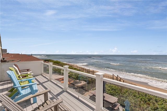 exterior space with a water view and a beach view