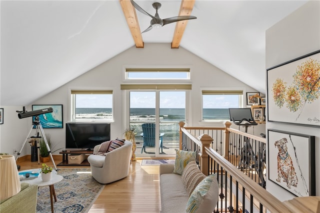 living room featuring lofted ceiling with beams, light hardwood / wood-style floors, and ceiling fan