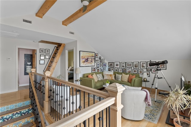 interior space featuring wood-type flooring and vaulted ceiling with beams