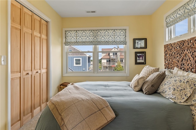 carpeted bedroom featuring a closet