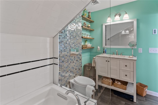 bathroom featuring vanity, a bathtub, hardwood / wood-style flooring, tile walls, and toilet