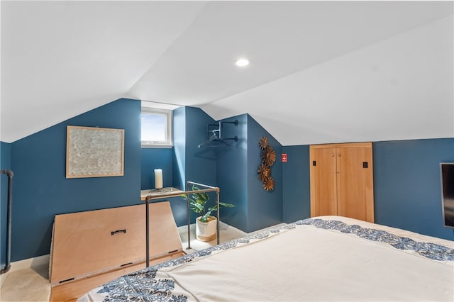 bedroom with carpet floors and vaulted ceiling