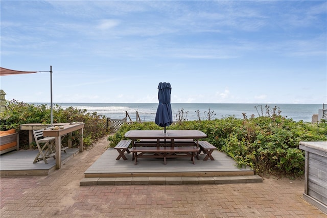 view of patio featuring a deck with water view