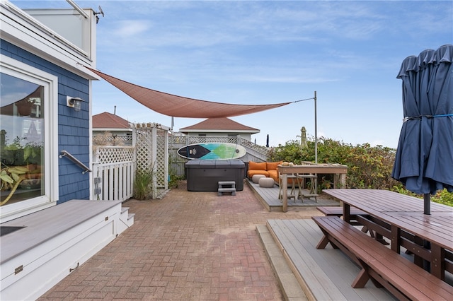 view of patio / terrace featuring a deck and a hot tub