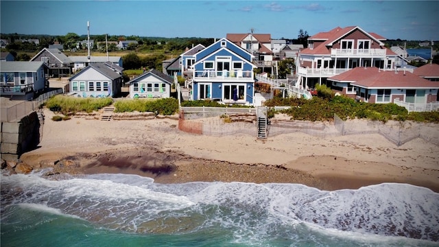 exterior space featuring a water view and a beach view