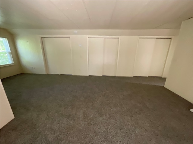 unfurnished bedroom featuring multiple closets