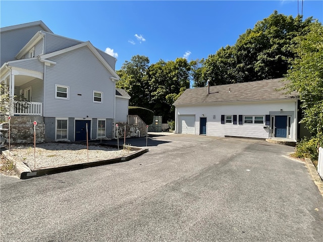 view of front of property with an outdoor structure and a garage