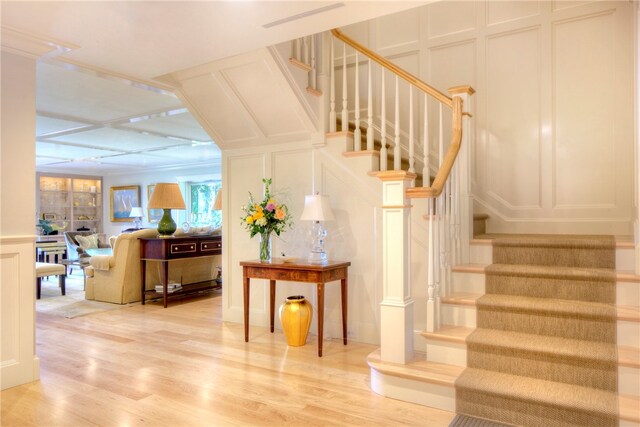 stairs featuring hardwood / wood-style floors