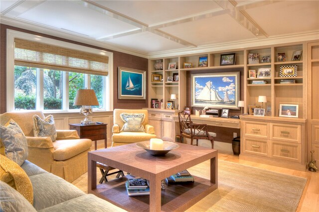 living room featuring coffered ceiling, hardwood / wood-style flooring, and ornamental molding