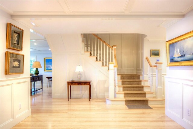 stairway featuring hardwood / wood-style flooring and crown molding