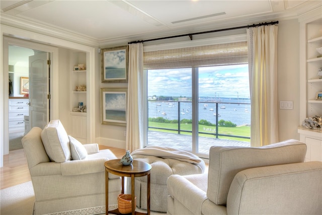 interior space featuring a water view, built in shelves, light hardwood / wood-style floors, and ornamental molding