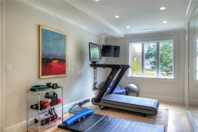 workout room with crown molding and hardwood / wood-style flooring