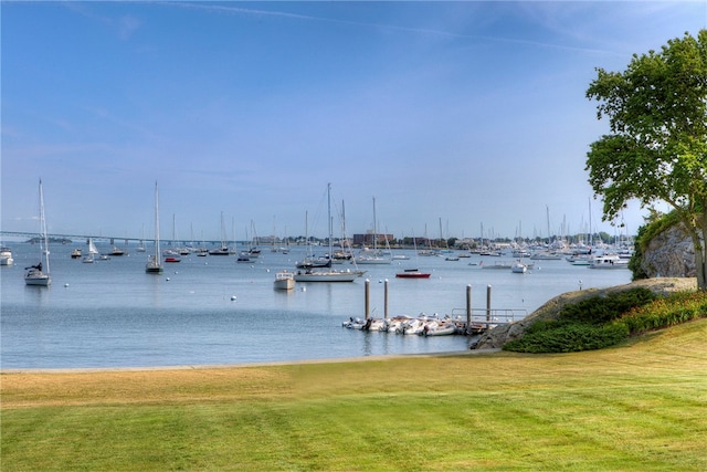 view of dock featuring a water view and a lawn