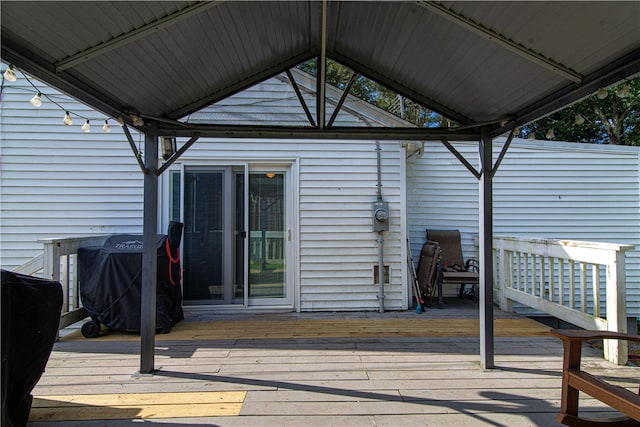 wooden terrace featuring area for grilling